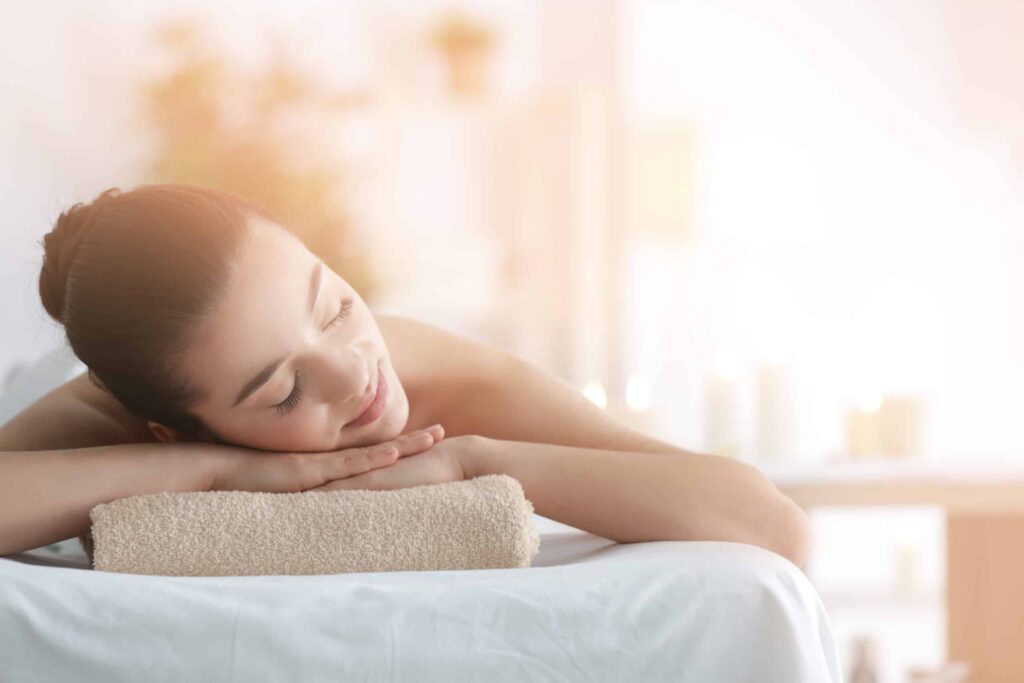 Massage therapist giving a relaxing back massage at Indulge Salon & Day Spa in Carrollton, GA